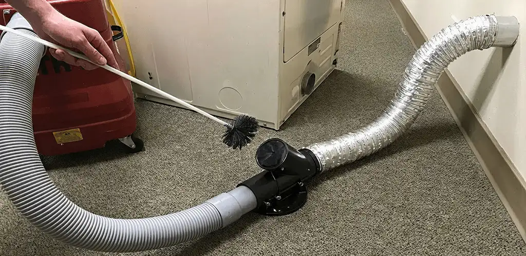 Dryer vent cleaning service removing lint from a dryer duct connection in Mobile, AL