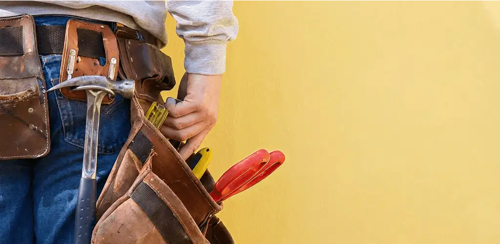 Handyman with tool belt ready for home repairs and maintenance in Mobile, AL