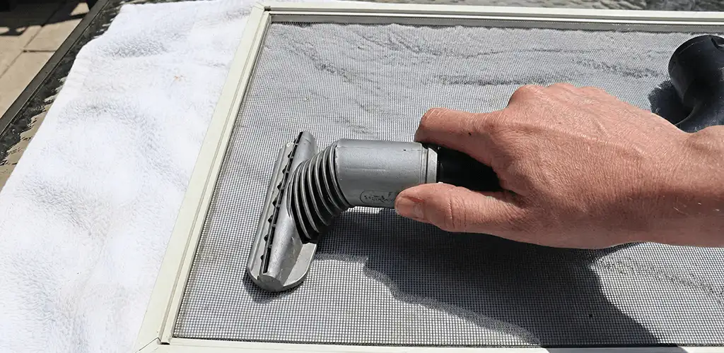 Window screen repair cleaning and fixing a damaged screen mesh in Mobile, AL